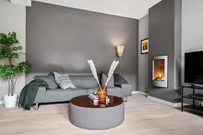 a living room with a couch and a table at Modern Apartment In The Heart of Bergen in Bergen