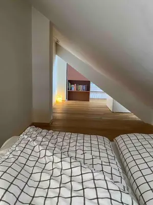 a white bed in a room with a staircase at Moderne og sentral leilighet på Geilo in Geilo