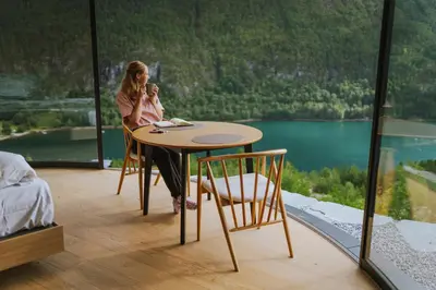 two women sitting at a table in a room with a view at Sogndal Fjordpanorama- The Panorama View in Kaupanger