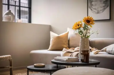a living room with a vase of sunflowers on a table at Stay l Luxurious Hideaway in Centrum in Bergen