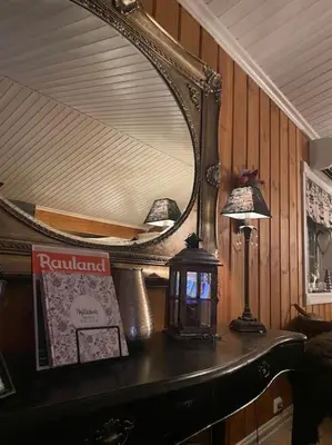 a mirror on top of a table with a lamp at Heimro in Torvetjørn