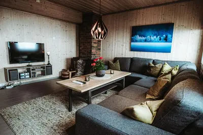 a living room with a couch and a table at Halne Fjellstugu in Maurset