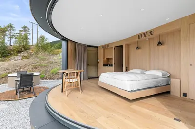a bedroom with a bed and a desk and a mirror at Sogndal Fjordpanorama- The Panorama View 2 in Sogndal