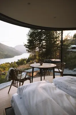 a room with two beds and a table with a view at Sogndal Fjordpanorama- The Panorama View 2 in Sogndal