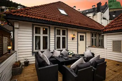 a patio with a table and chairs on a house at Central stay apartment - 401 in Bergen