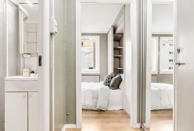 a bedroom with a bed and a large mirror at Charming studio apartment in Bergen