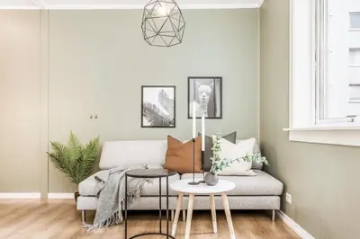 a living room with a couch and a table at Charming studio apartment in Bergen