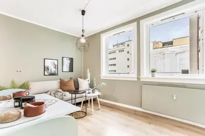 a living room with a couch and a table at Charming studio apartment in Bergen