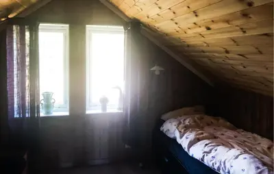 a bedroom with a bed and two windows at Stunning Home In Lensvik With Wifi in Lensvik