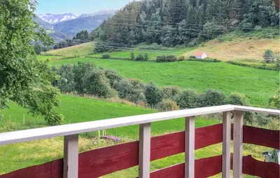 a balcony with a view of a field and mountains at 3 Bedroom Beautiful Home In Vik I Sogn in Stadheim