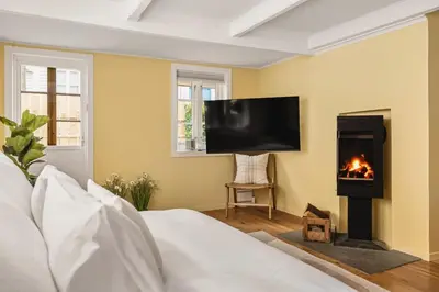 a living room with a fireplace and a tv at Dinbnb Homes I Bergen's #1 BNB I Jacuzzi & Fireplace & Balcony in Bergen