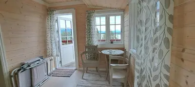 a small room with a table and a window at Vesletun in Balestrand