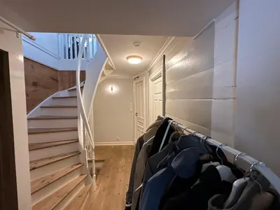 a room with a staircase and a closet with clothes at Sjarmerende bolig like ved togstasjonen in Bergen