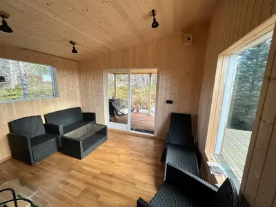 a room with chairs and a table in a house at Feriehus nær sjøen på Kvenvær in Hitra