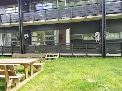 a building with a picnic table in front of it at Fin leilighet i Geilo sentrum - kort vei til alt in Geilo