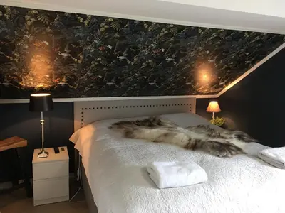 a bedroom with a bed with a cat blanket on it at Villa Skoglund in Stranda