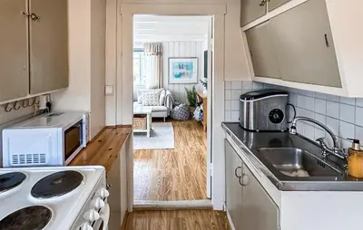 a kitchen with a sink and a stove at 3 Bedroom Stunning Home In Vikebygd in Vikebygd