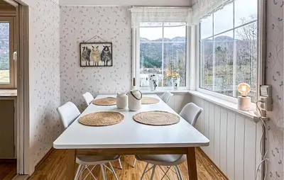 a dining room with a white table and chairs at 3 Bedroom Stunning Home In Vikebygd in Vikebygd