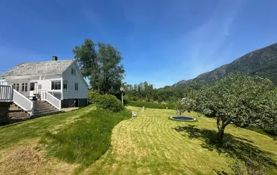 a white house with a yard with a frisbee at 3 Bedroom Stunning Home In Vikebygd in Vikebygd