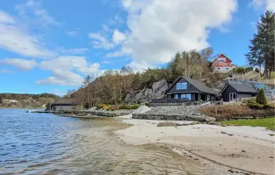 a house on the shore of a body of water at Stunning Home In Sveio With Kitchen in Sveio