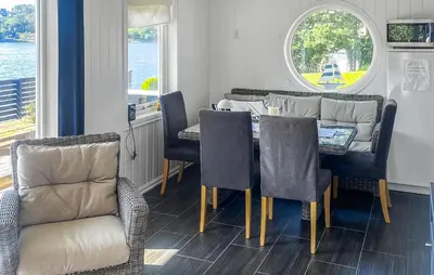 a dining room with a table and chairs and a window at Stunning Home In Sveio With Kitchen in Sveio
