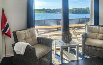 a living room with two chairs and a fireplace at Stunning Home In Sveio With Kitchen in Sveio