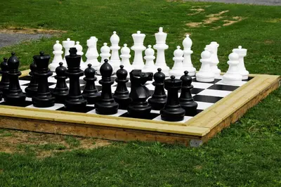a chess board sitting on the grass in a yard at Camp Sjusjøen in Mesnali