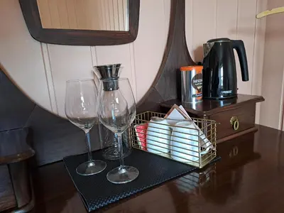 two wine glasses and a basket on a table at Bay View Island Room - Svanøy in Svanøy