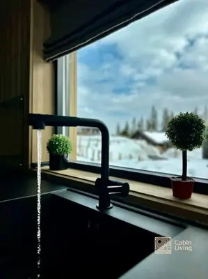 a kitchen sink with water coming out of a faucet at New cabin at Skeikampen, perfect for families! in Svingvoll