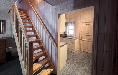 a staircase leading to a kitchen in a log cabin at Gorgeous Home In Venabygd With Sauna in Venabygd