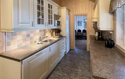 a kitchen with white cabinets and a sink at Gorgeous Home In Venabygd With Sauna in Venabygd