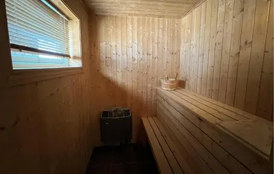 a wooden sauna with a window and a bench in it at Gorgeous Home In Venabygd With Sauna in Venabygd