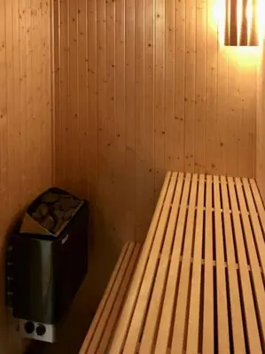a room with a bed and a trash can at New log cabin with sauna, waxing shed & bench at Sjusjøen in Ringsaker