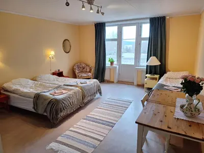 a bedroom with a bed and a table in it at Hurdal Gjestegård in Hurdal