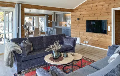 a living room with a couch and a table at Awesome Home In Stryn in Stryn