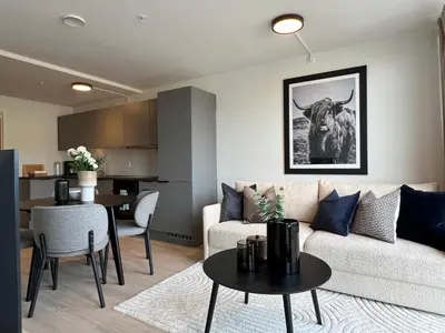 a living room with a couch and a table at Høyegaarden in Bergen