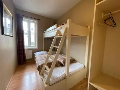 a room with a bunk bed with a ladder at Relaxing Retreat With Two Terraces in Beitostøl