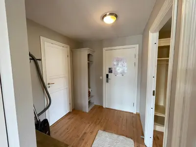 an empty room with a hallway with two white doors at Relaxing Retreat With Two Terraces in Beitostøl