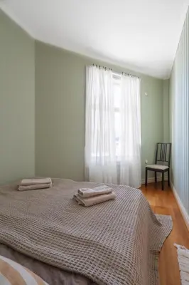 a bedroom with a bed with two towels on it at Sunny apartment in Ålesund city in Ålesund