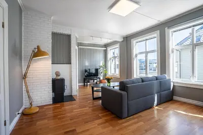 a living room with a couch and a table at Sunny apartment in Ålesund city in Ålesund