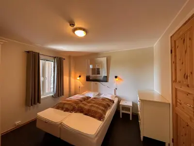 a bedroom with a bed and a window at Enjoy Comfort Wi-Fi, Sauna & More! in Beitostøl