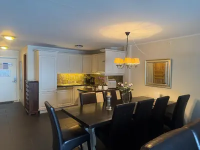 a kitchen and dining room with a table and chairs at Enjoy Comfort Wi-Fi, Sauna & More! in Beitostøl