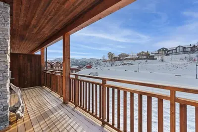 a balcony with a view of a snow covered yard at Cozy Apartment close to Hovden alpine centre in Hovden