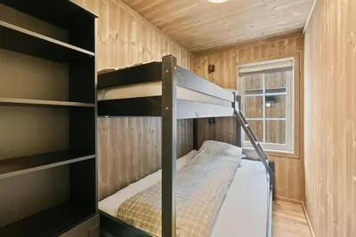 a small room with a bunk bed and a window at Cozy Apartment close to Hovden alpine centre in Hovden