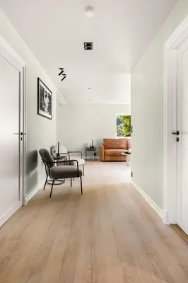 an empty living room with a chair and a couch at Odda Atmosphere in Odda