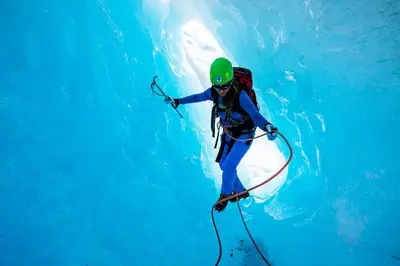 a person in the water with a backpack and a dolphin at Odda Atmosphere in Odda