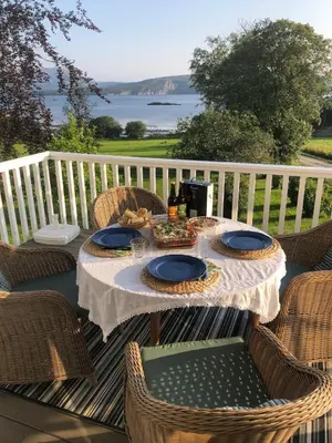 a table with a plate of food on a patio at Stenegården in Namsos
