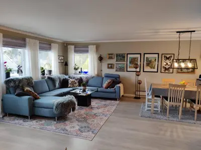 a living room with a blue couch and a table at Nearby Bergen, Midtunlia 27d in Bergen