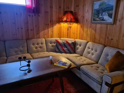 a living room with a couch and a coffee table at Hyttepreget overnattingssted in Geilo