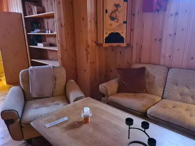 a living room with a table and two chairs at Hyttepreget overnattingssted in Geilo